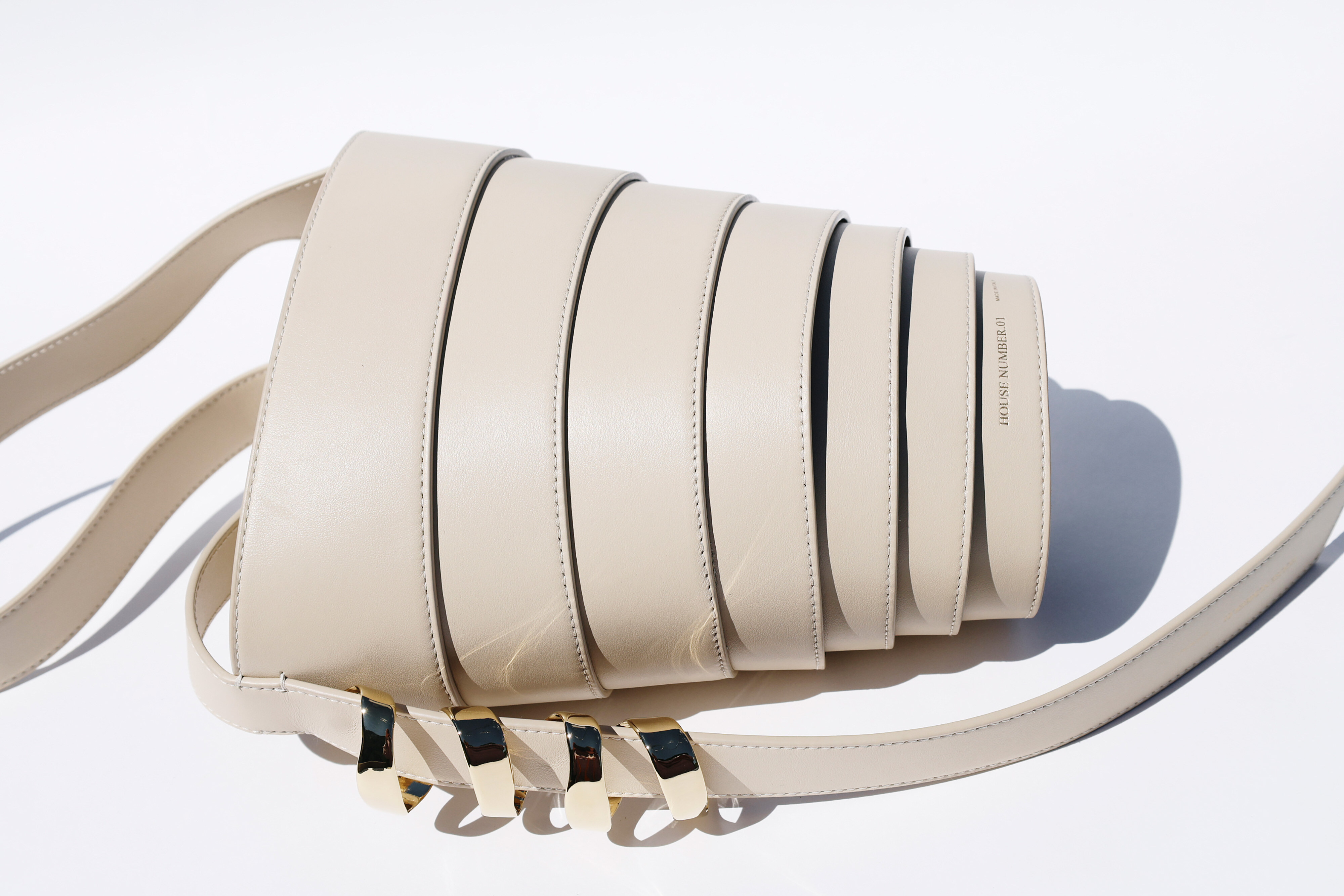 The Spiral Bag in cream, on its side