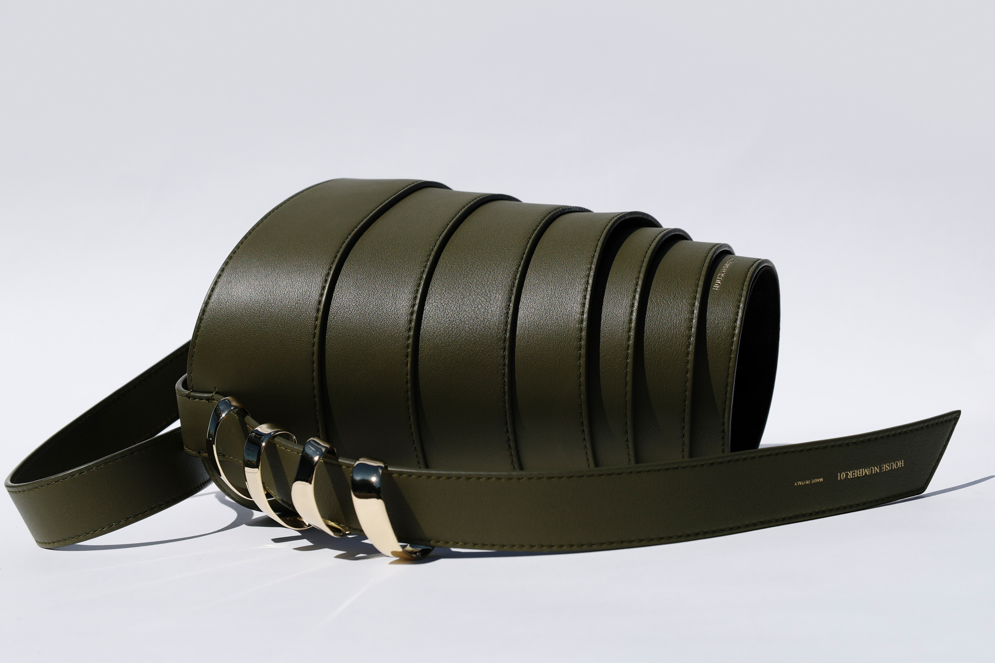 Olive leather belt, coiled