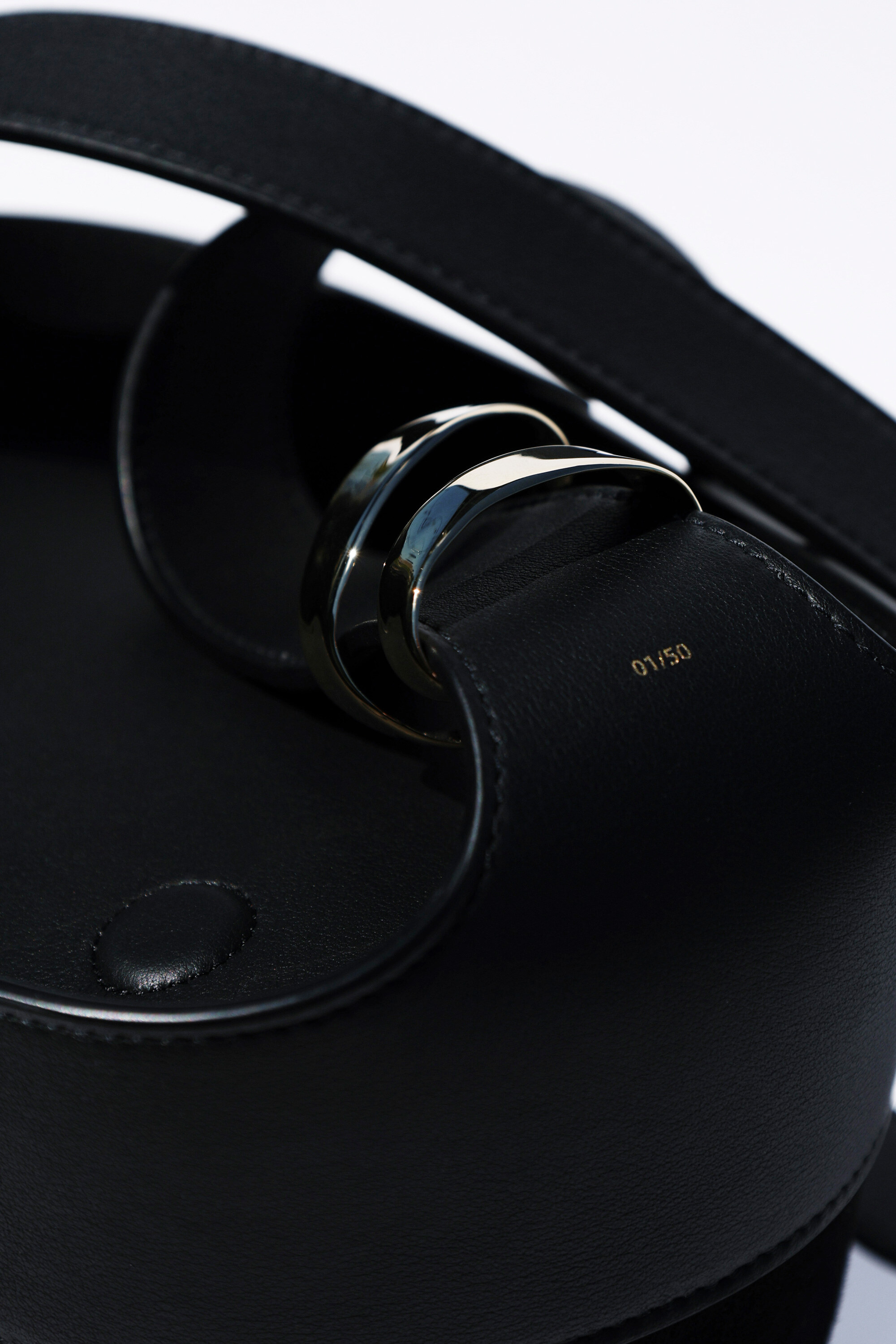 Black leather hardware stamped 01/50